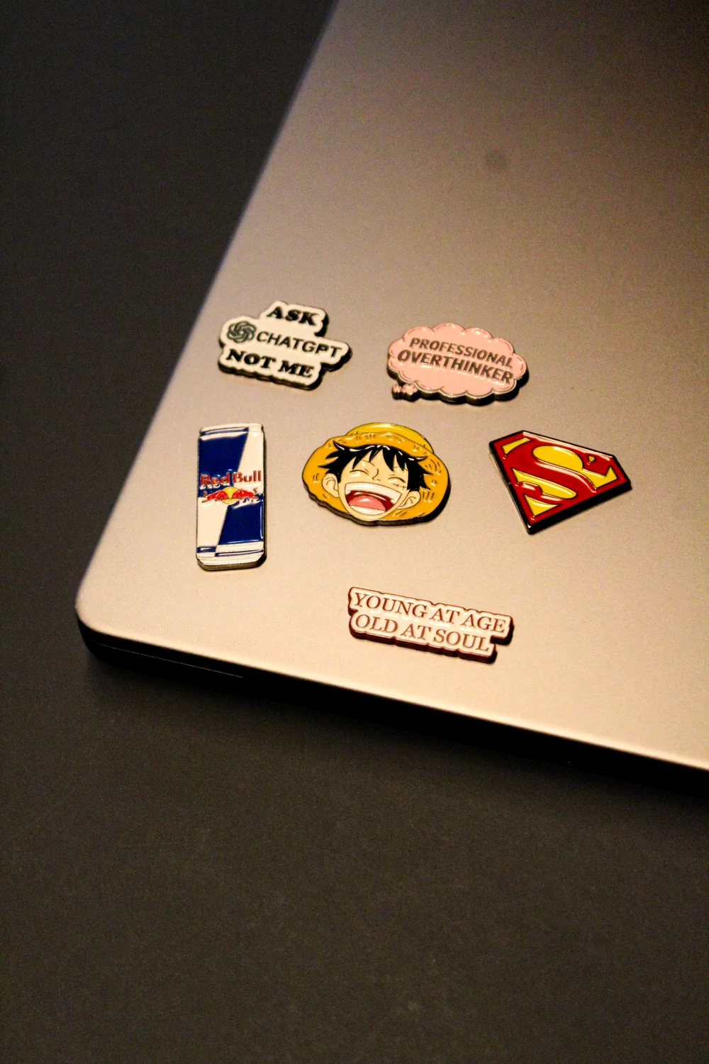 A laptop decorated with playful pop culture enamel stickers