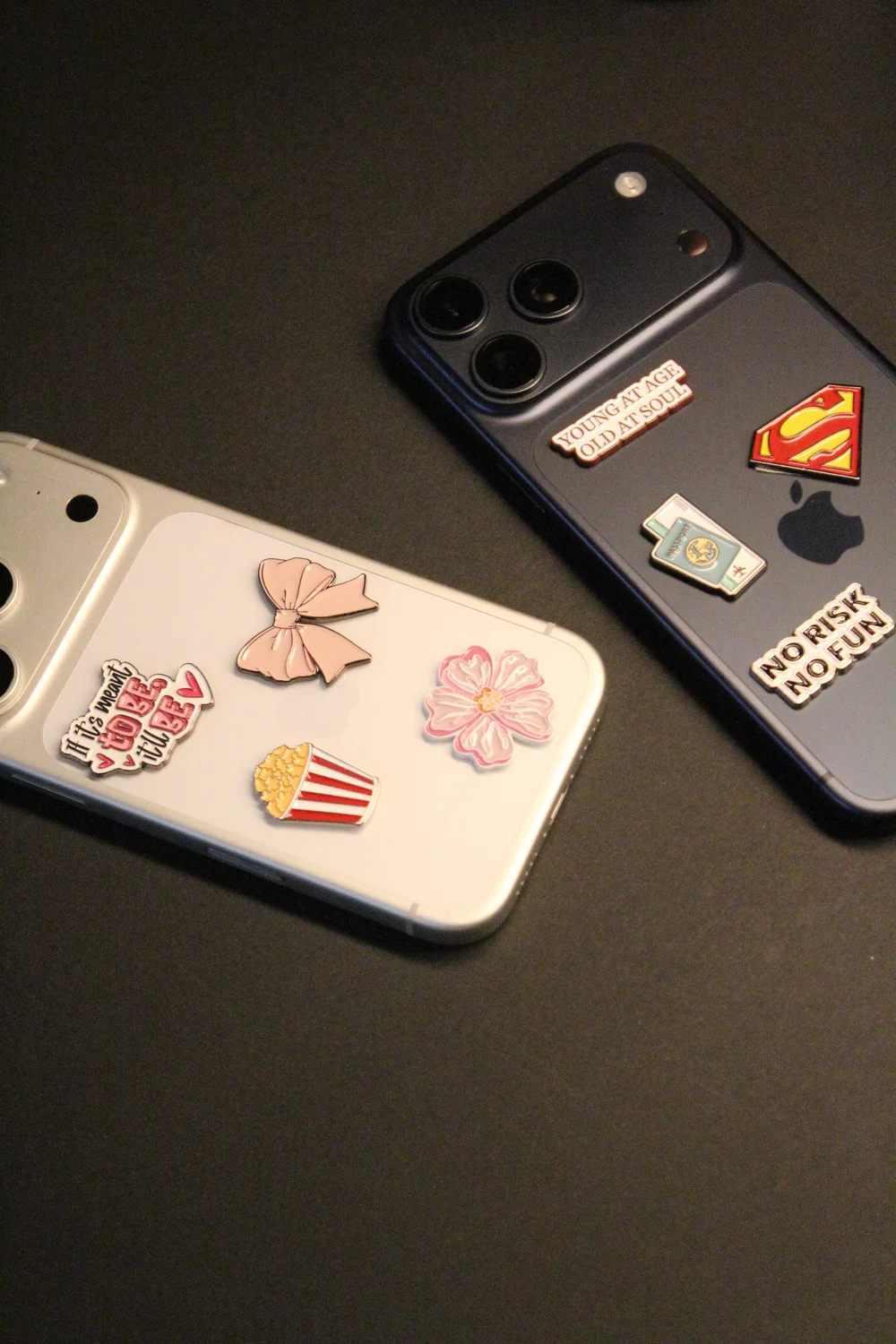 Two phones personalised with bows, flowers and travel enamel stickers